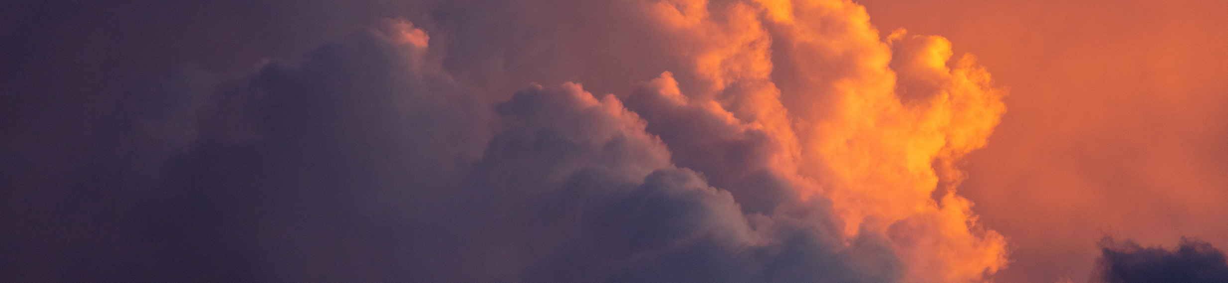 Sunset casting pink and purple colors onto storm clouds