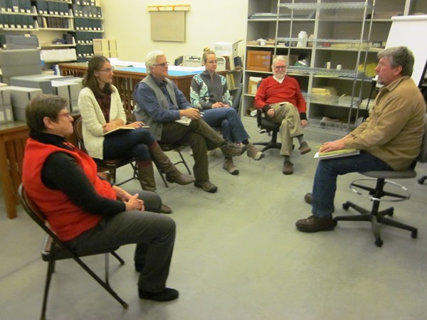 Participants in the archives blitz processing project discuss the next step, November 2014.