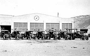 (YELL-2012-2) Another recent acquisition to the photo archives shows part of the YPT Co. fleet of maintenance or service vehicles in Gardiner. Note the tripod or "V Bar" mounted on the beds of the vehicles.