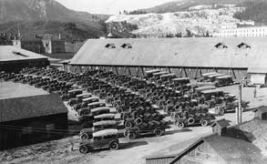 (YELL 33925) The Yellowstone Park Transportation Company fleet at Mammoth Hot Springs headquarters in 1920. White Motor Company seven-passenger touring cars are at the left foreground, most of the other vehicles are the eleven-passenger models. This facility and many of the vehicles were destroyed in a disastrous fire in 1925.