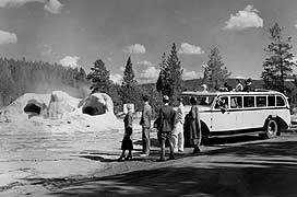 (YELL 90071-2) Northern Pacific Railway photo of 1936 Model 706 National Park Bus with visitors at Grotto Geyser.