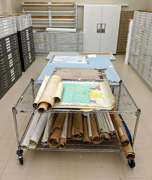 Rolled maps on a cart Cart containing rolled maps and drawings