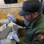 A park biologist prepares a sample