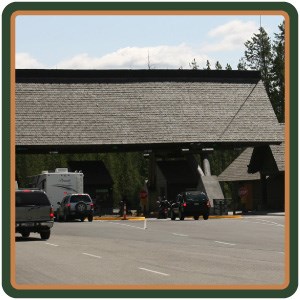 Vehicles pull up to the covered entrance booths.