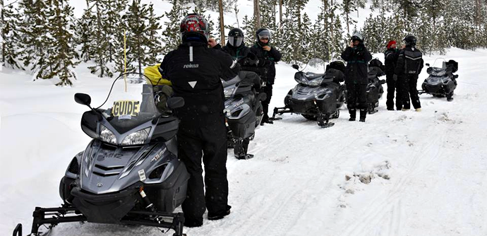 Snowmobile group with guide