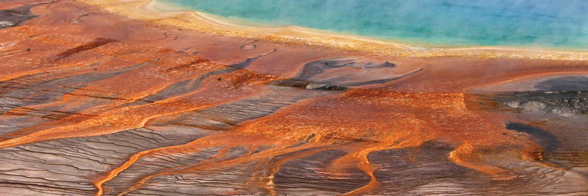 Bright colors stream from a steaming pool of water Bright colors stream from a steaming pool of water