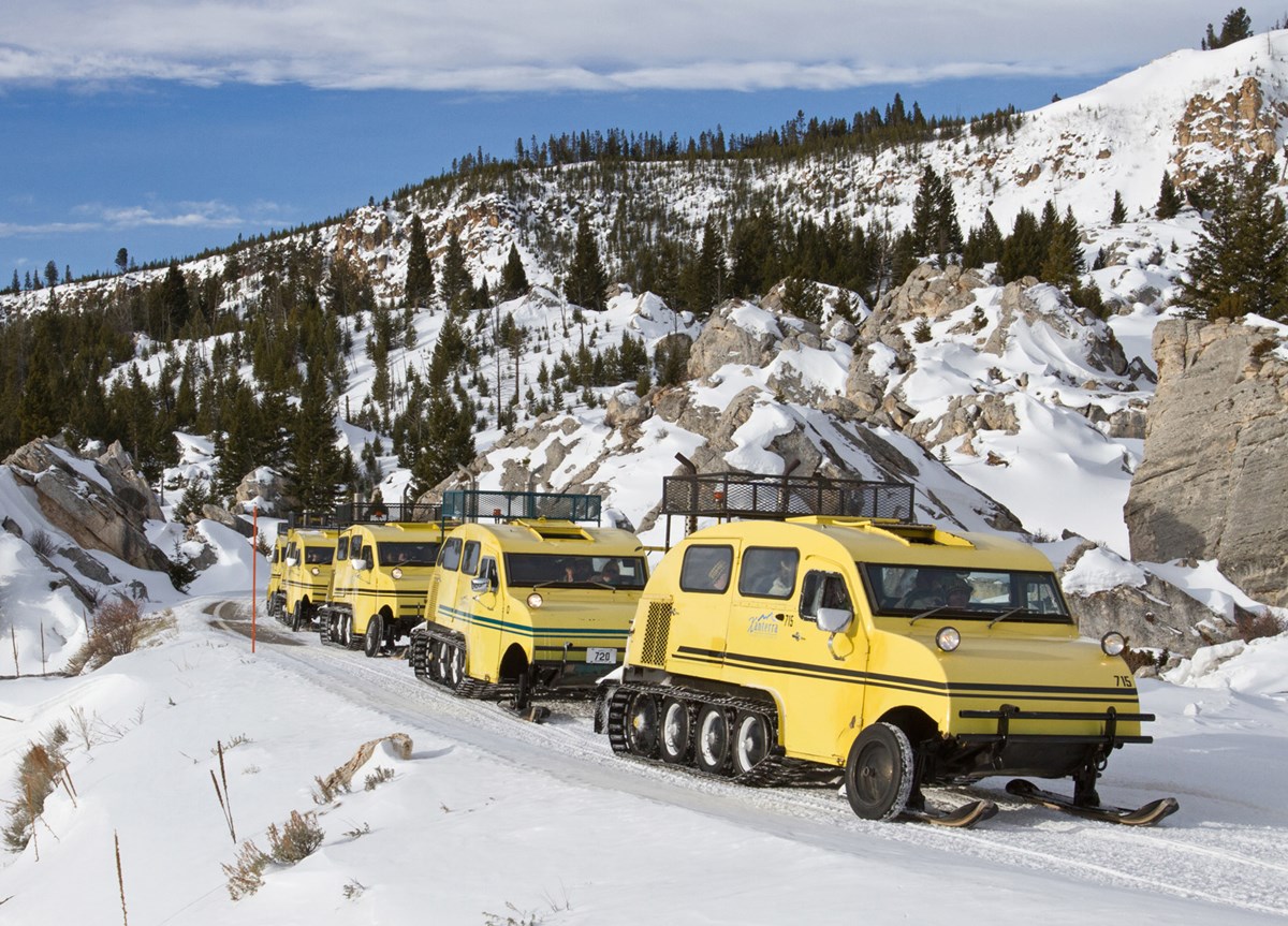 Bombardier snowcoaches make their way through the Hoodoos near Mammoth Hot Springs. Bombardier snowcoaches make their way through the Hoodoos near Mammoth Hot Springs.