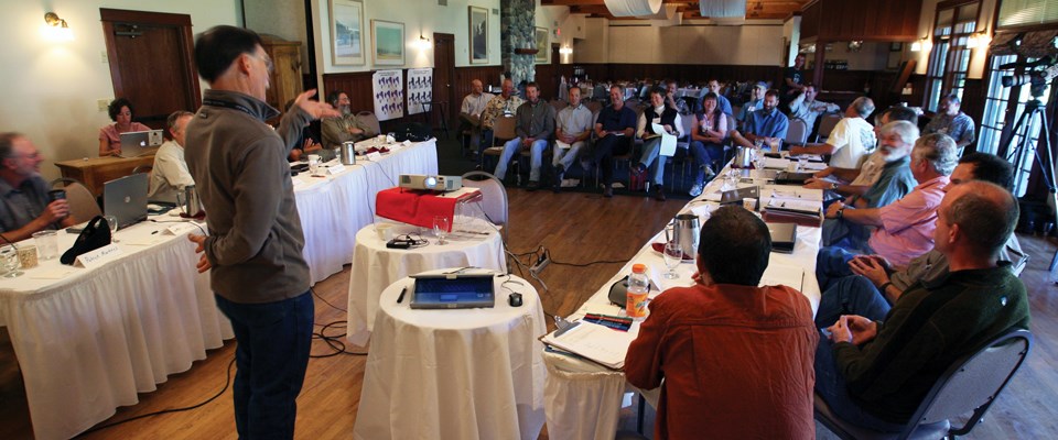 A group of people listen to a presenter