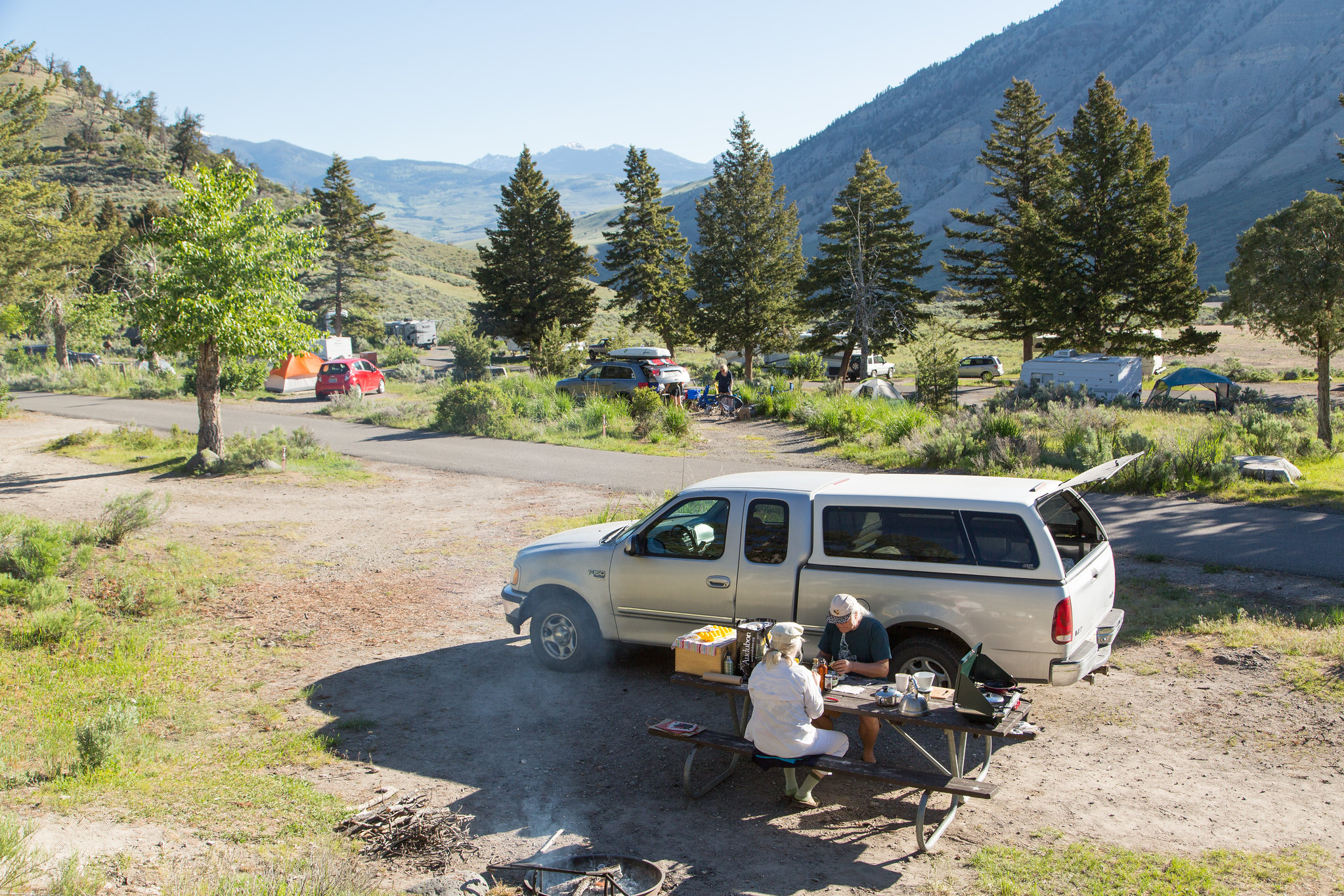 campground with campers at picnic table