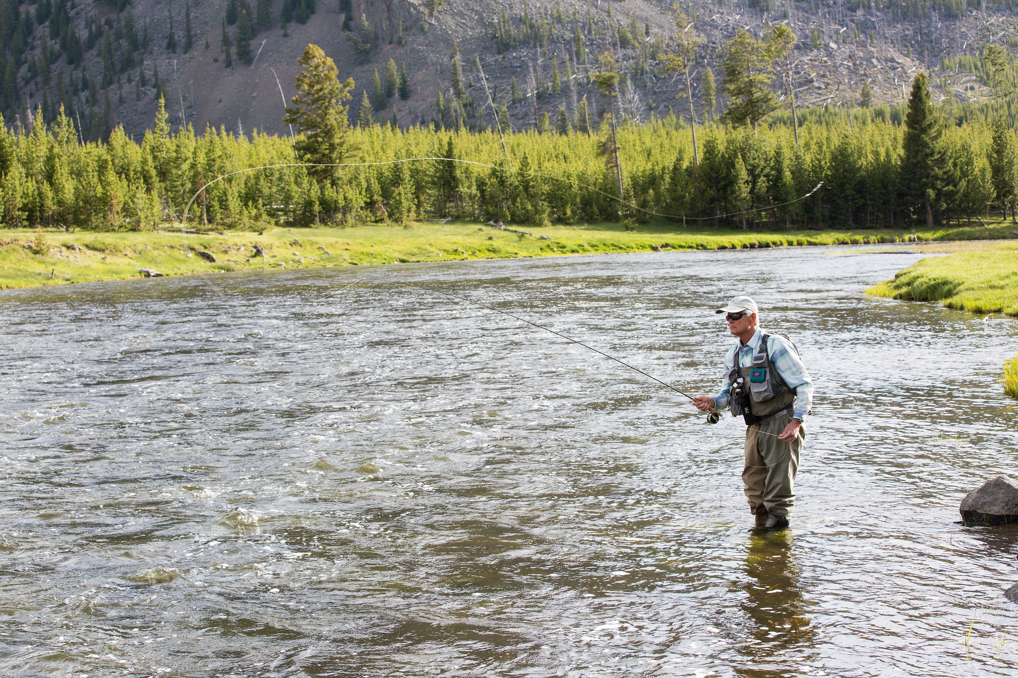 A man fly fishing in a river
