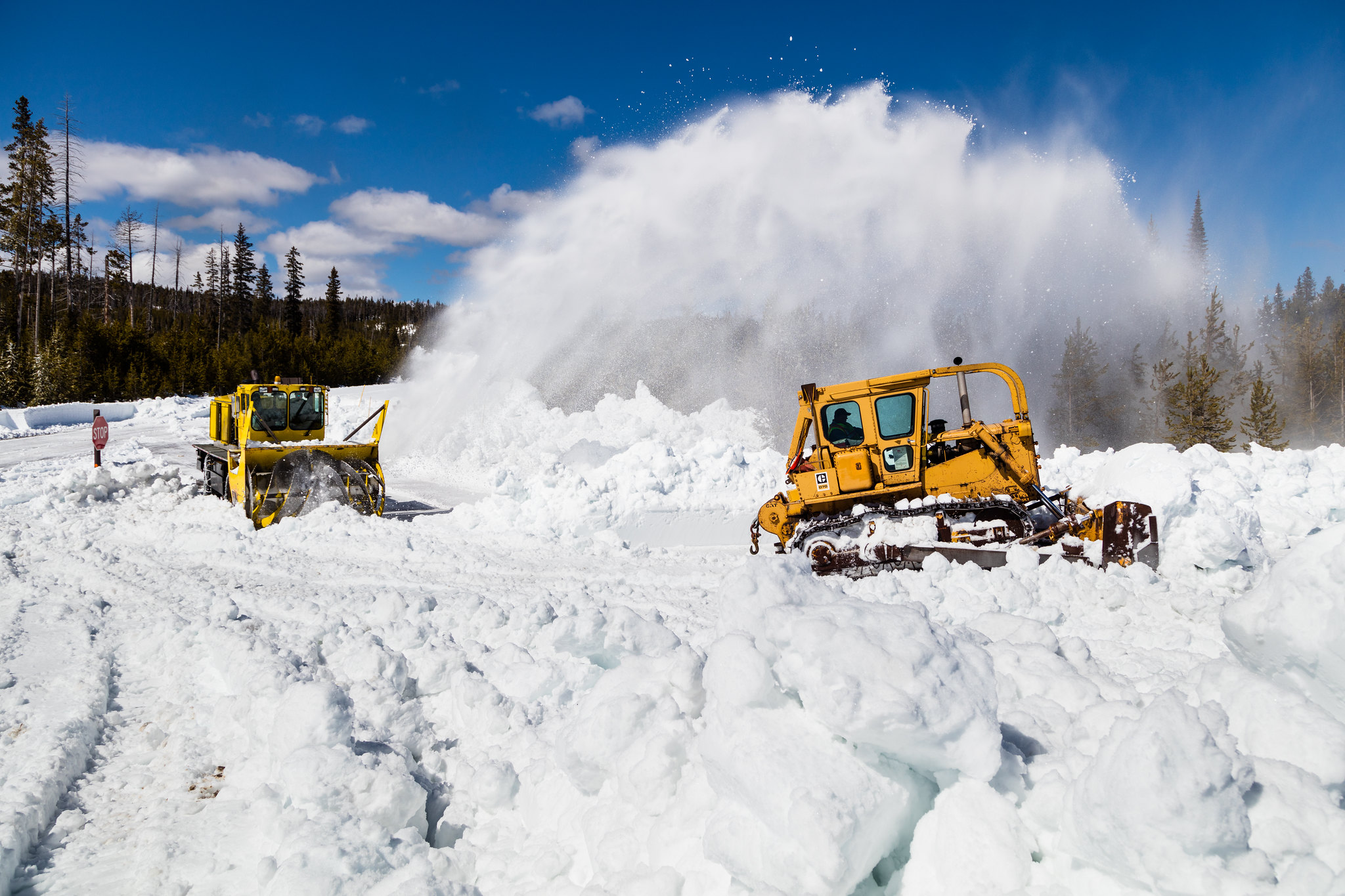 heavy equipment on a snowy road during plowing operations