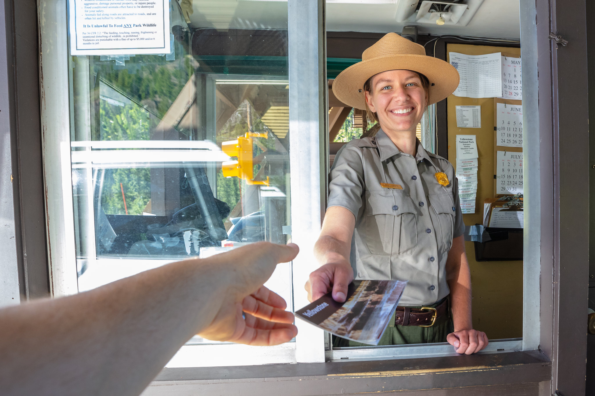 Ranger at East Entrance hands out a park map