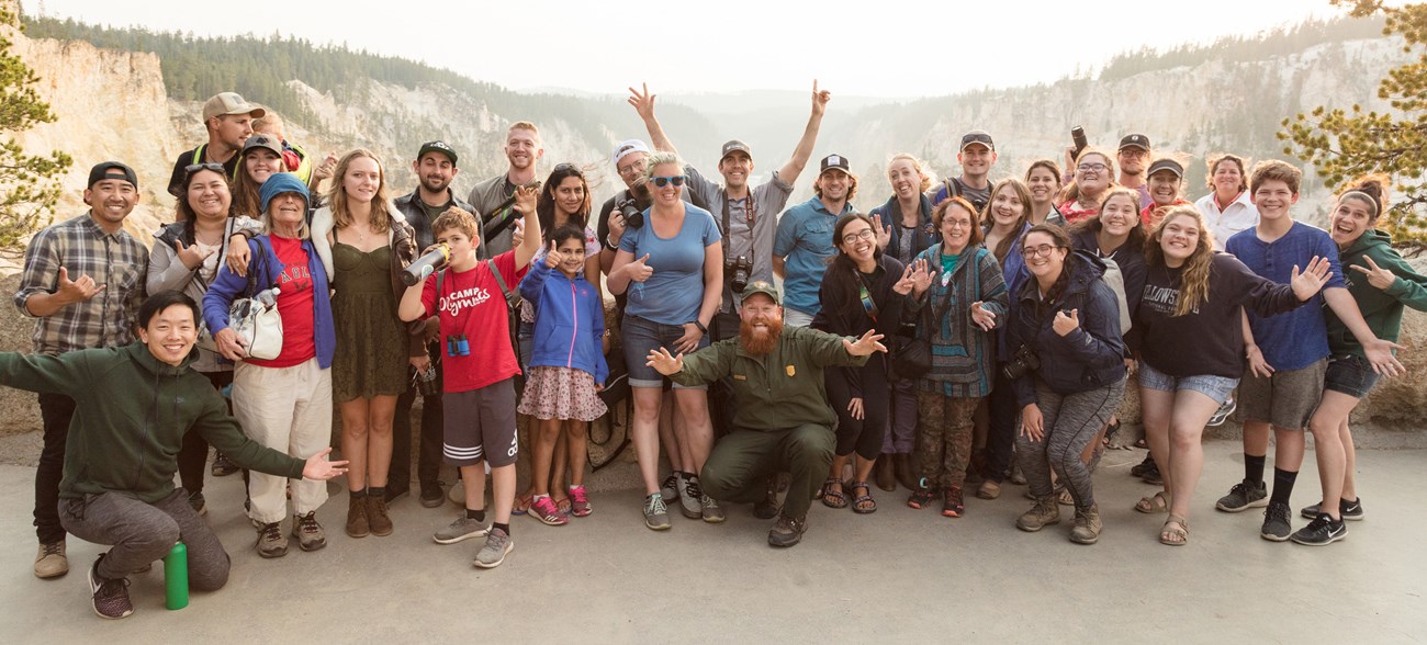 A large group of people are posing for a photo smiling for the camera