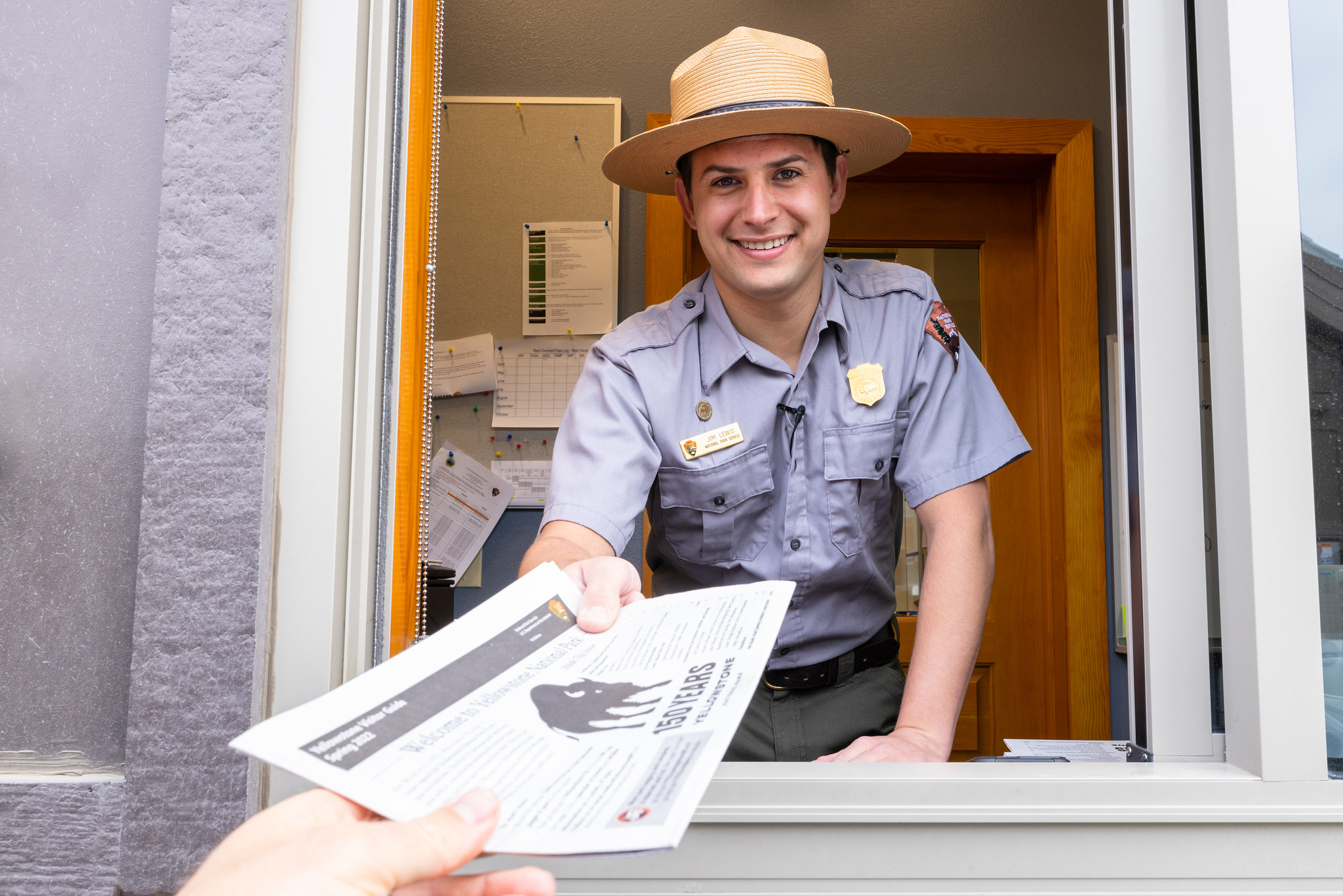 ranger welcoming visitor at entrance station