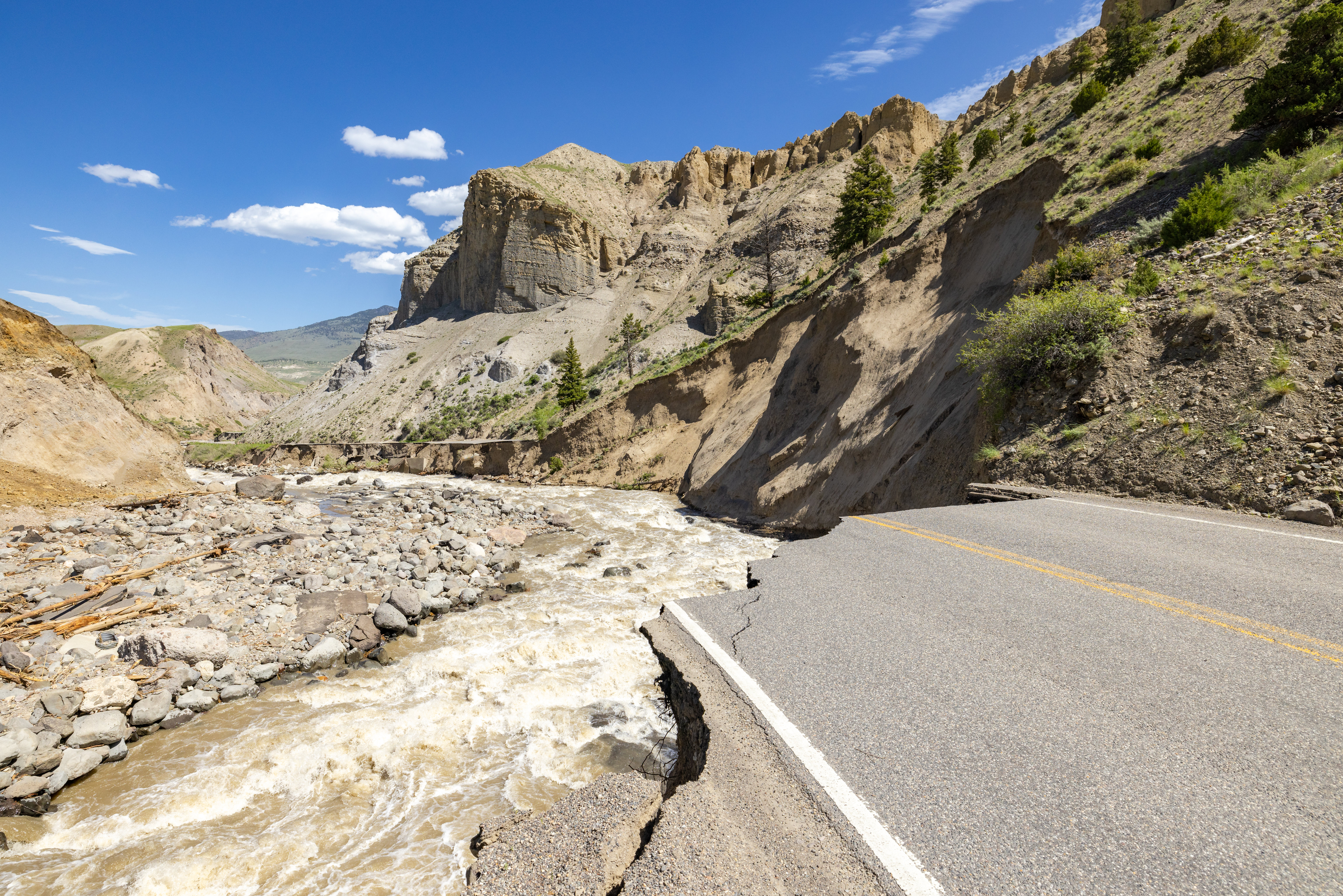 a damaged roadway near a river