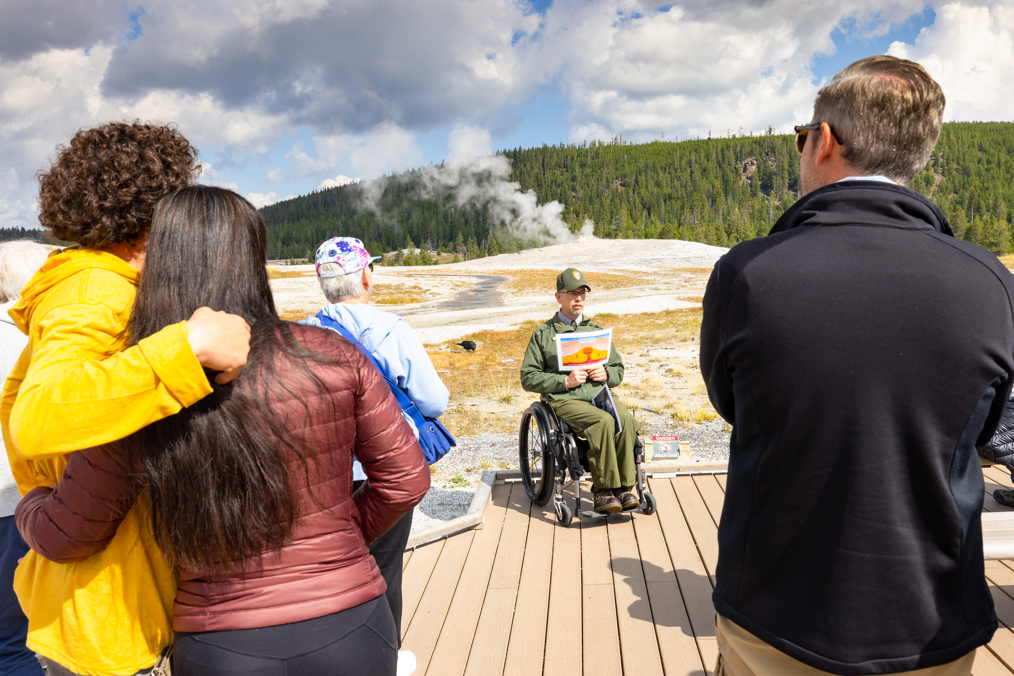 Ranger giving a program on the boardwalk at Old Faithful