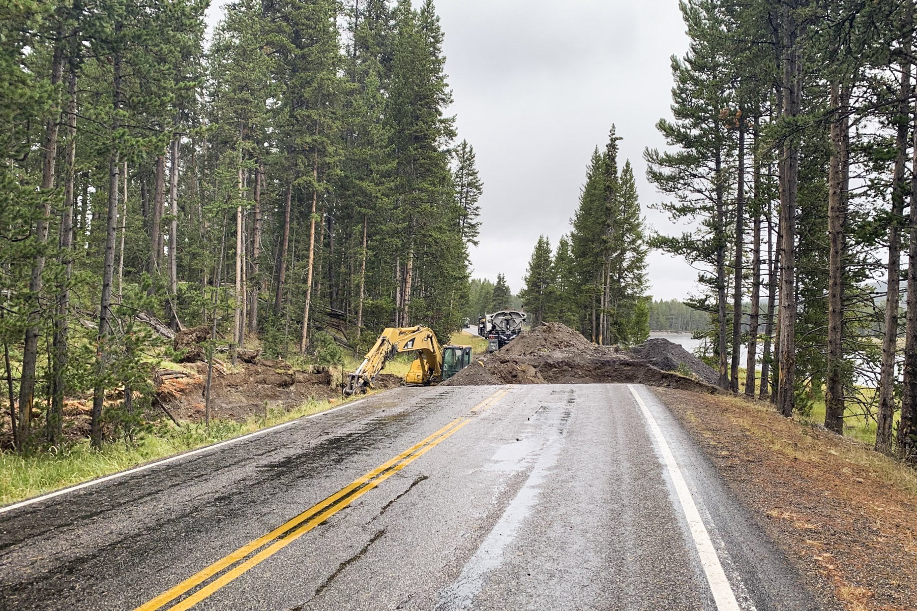 A hole that has been dug in a road to assess gasoline spill extent