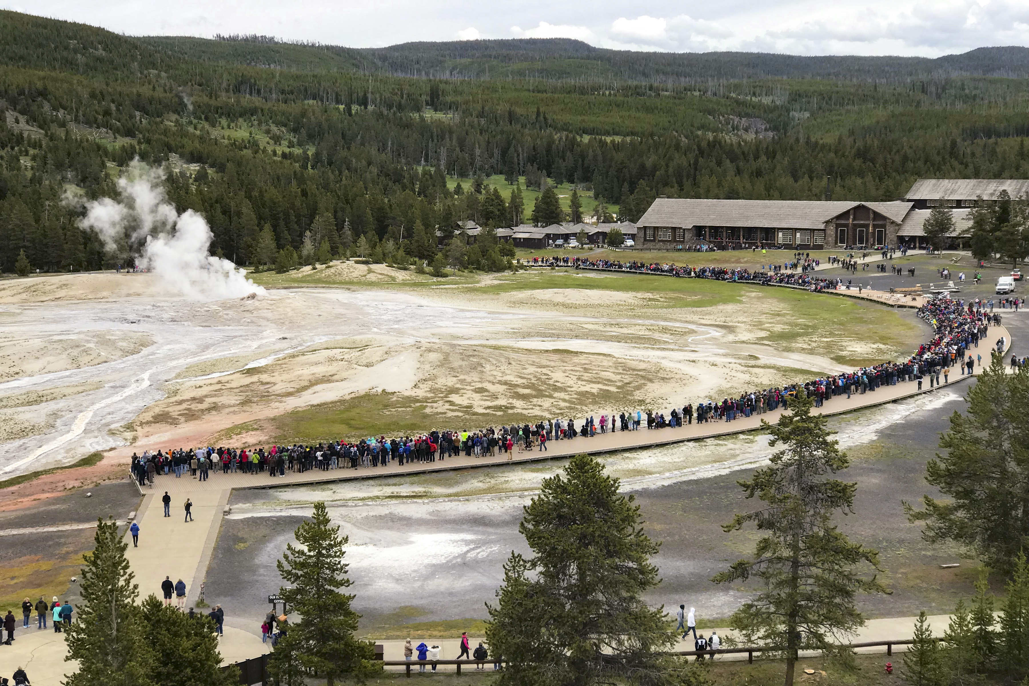 large crowd gathered around old faithful