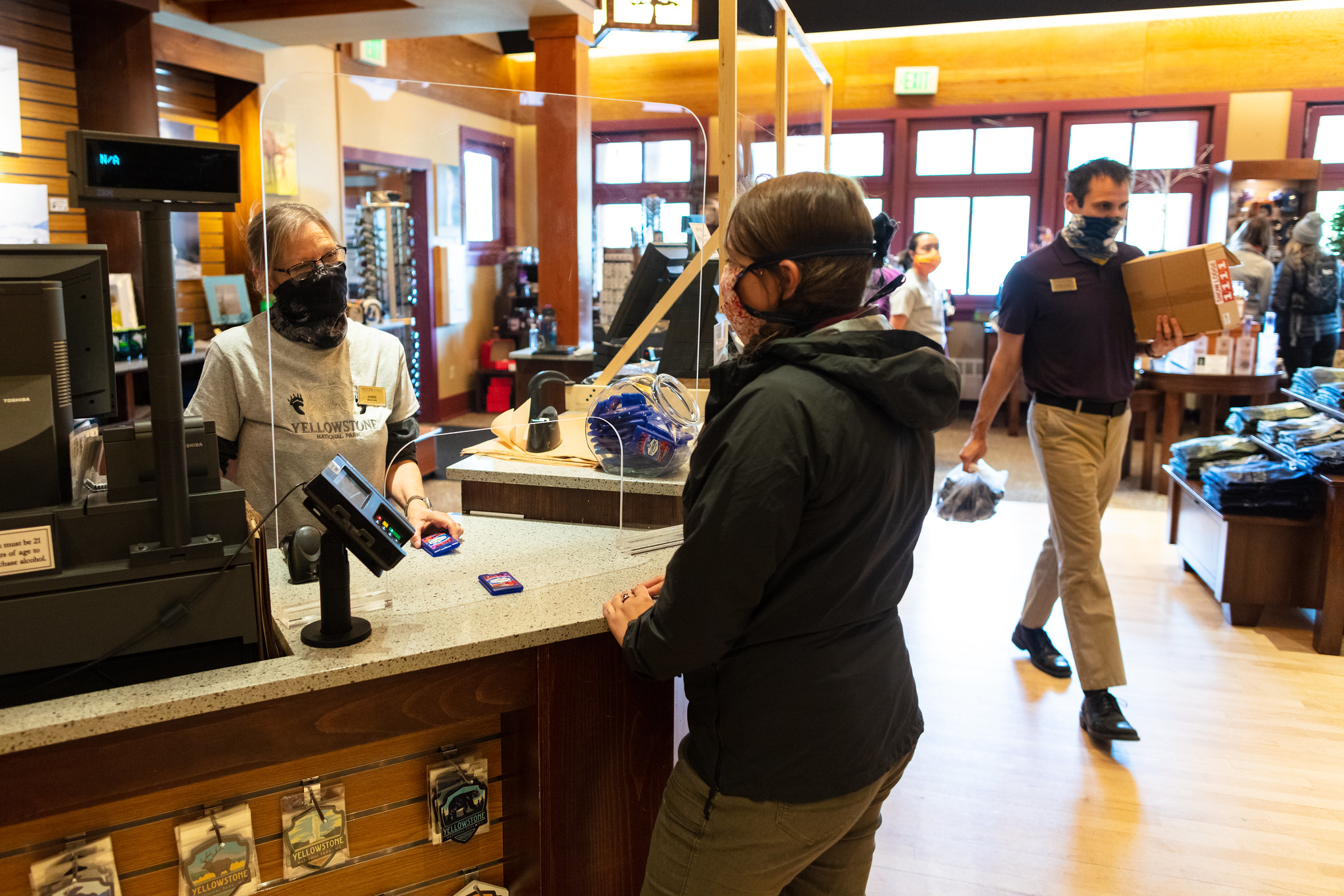 store employees assist visitors in gift shop