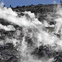 Steam rises from vents on a hill