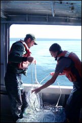 NPS staff working on boat.