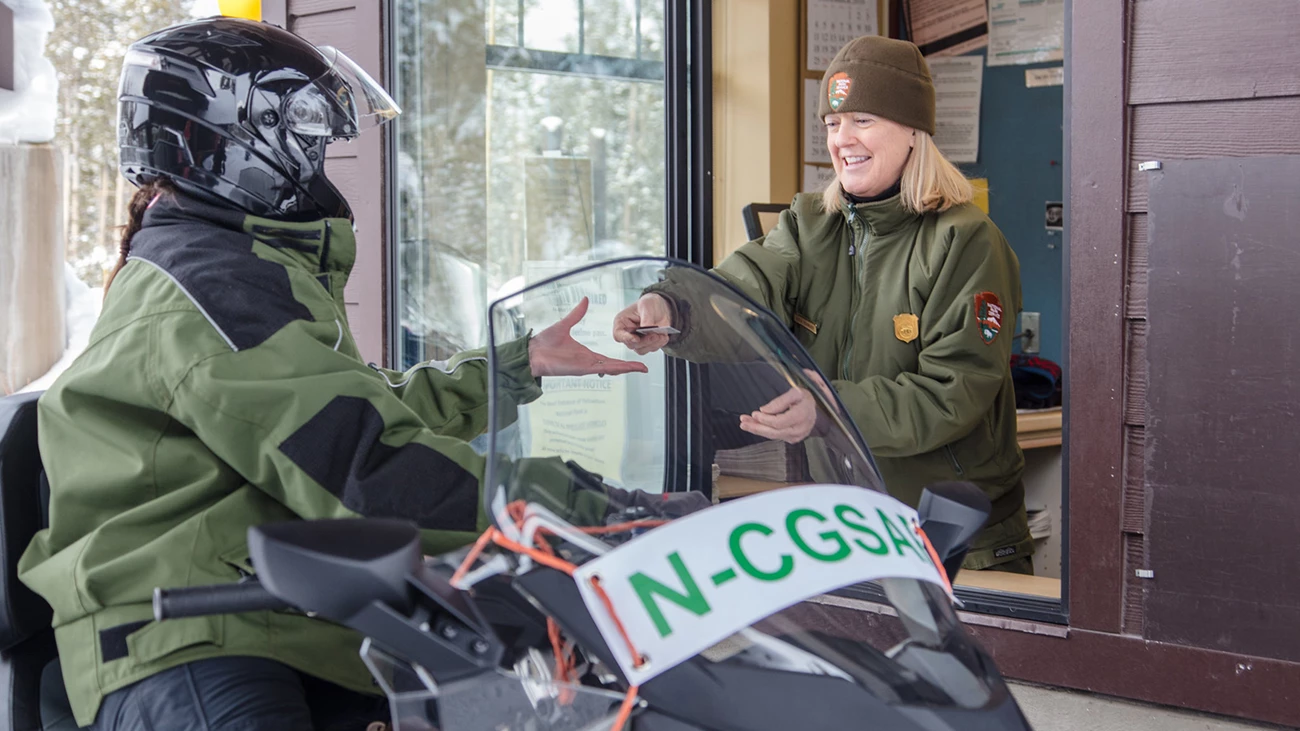 Snowmobiler at West Yellowstone Entrance station Snowmobiler at West Yellowstone Entrance Station