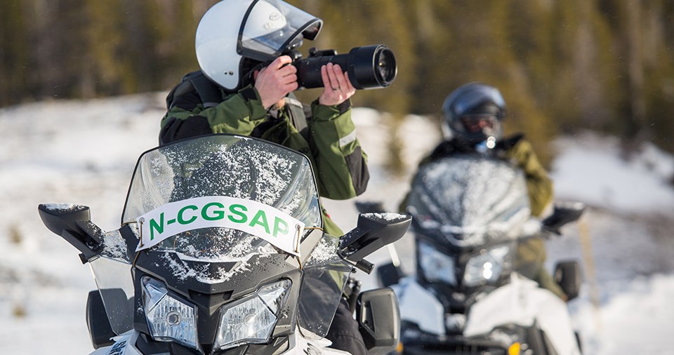 Snowbmobile riders stopped to take a photo