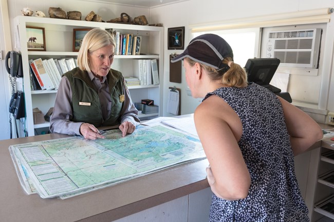 Ranger speaks with a person at a backcountry office