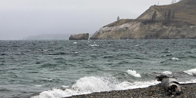 Small waves crash on a rocky shore