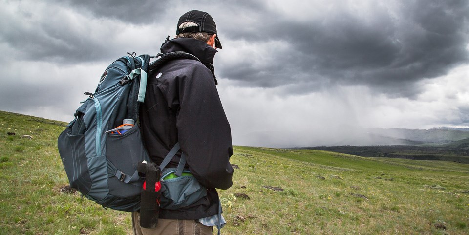 A hiker watches an oncoming storm on Specimen Ridge A hiker watches an oncoming storm on Specimen Ridge