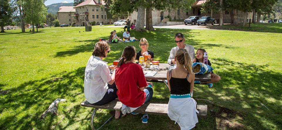 A group of visitors eating at a picnic table
