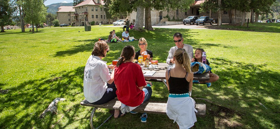 A group of visitors eating at a picnic table