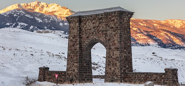 A stone archway straddles a small road.