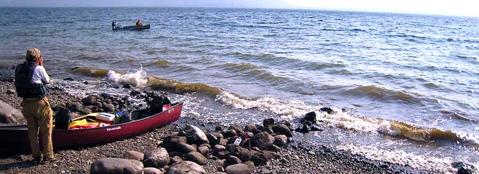 Visitor watching boat on lake. Visitor watching boat on lake.