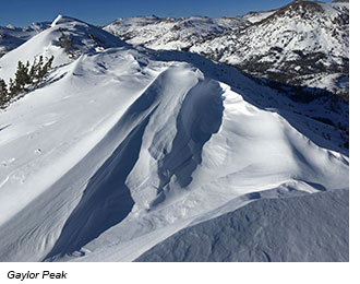 From atop a peak, a view of more snowy moountain peaks