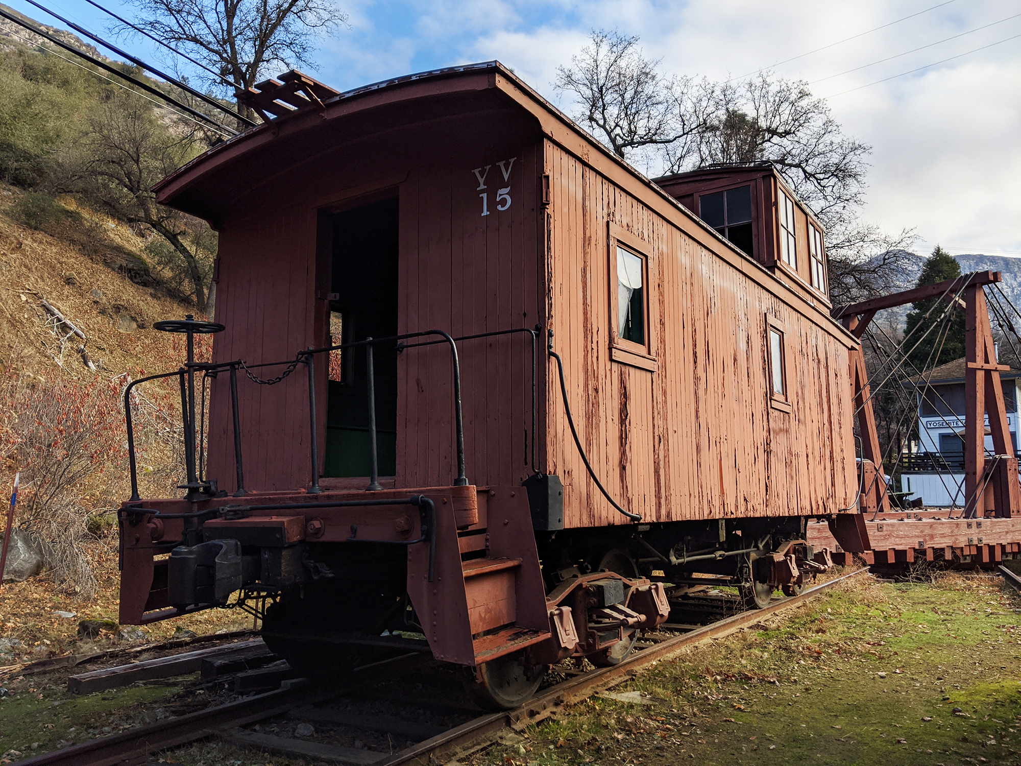 An old, red caboose sits in El Portal