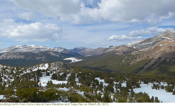 Mountainous landscape with a limited snow covering the meadow floor.