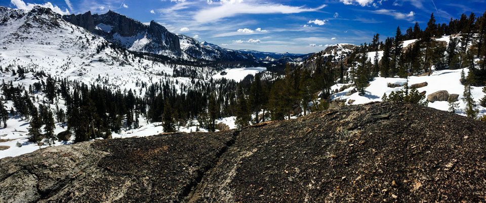 Sharp peaks protrude from a snowy mountain landscape