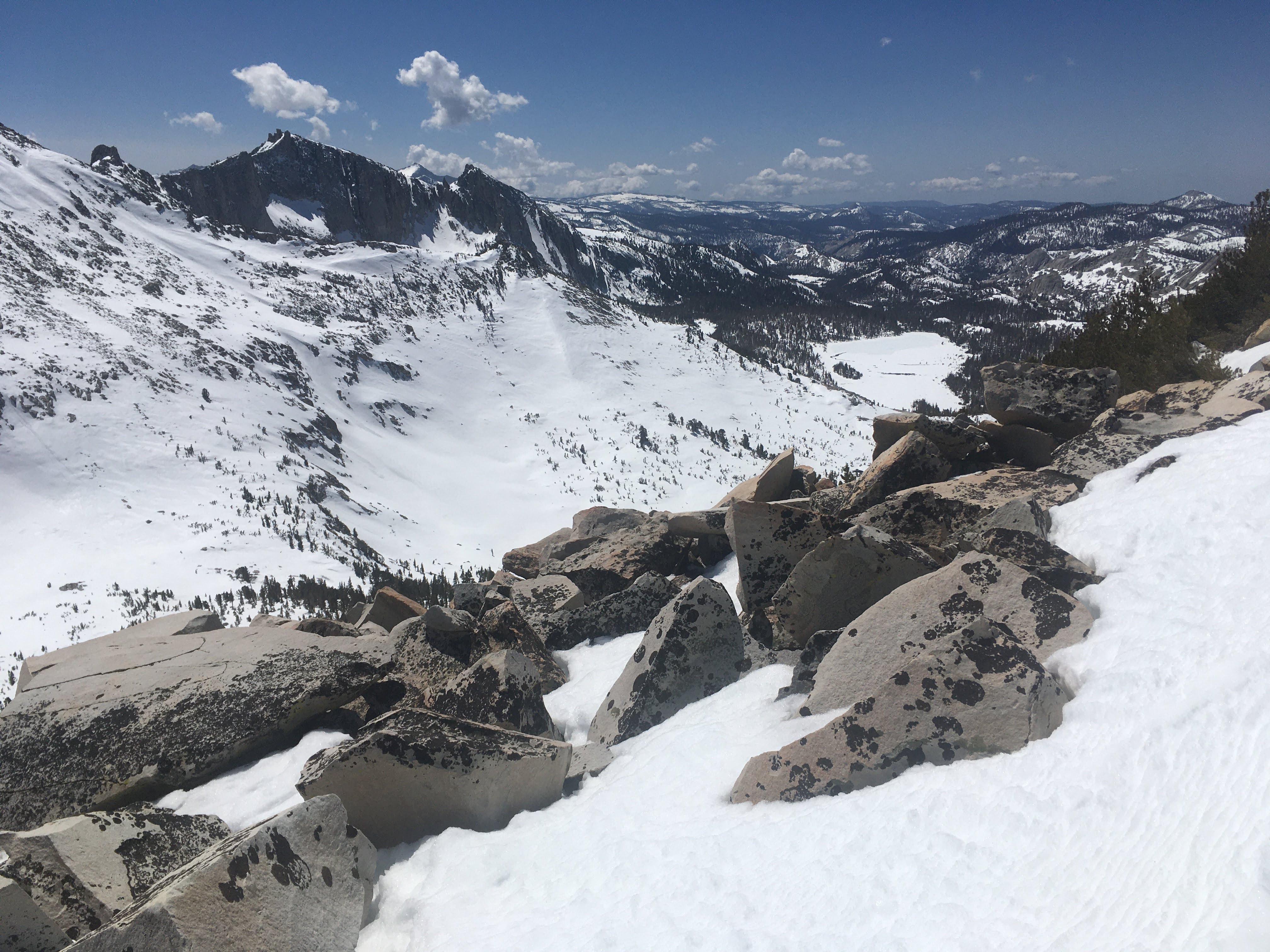 View of a mountain peak and snowy canyon below