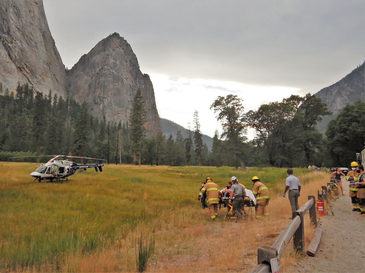 Search and rescue litter team carrying person to helicopter