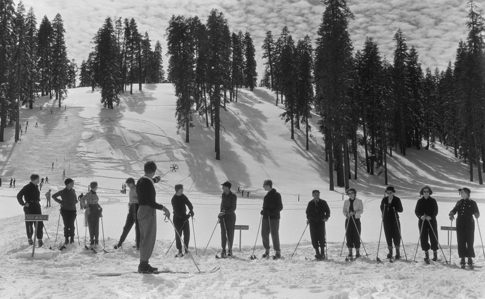 People standing in line at the bottom of a Badger Pass ski hill