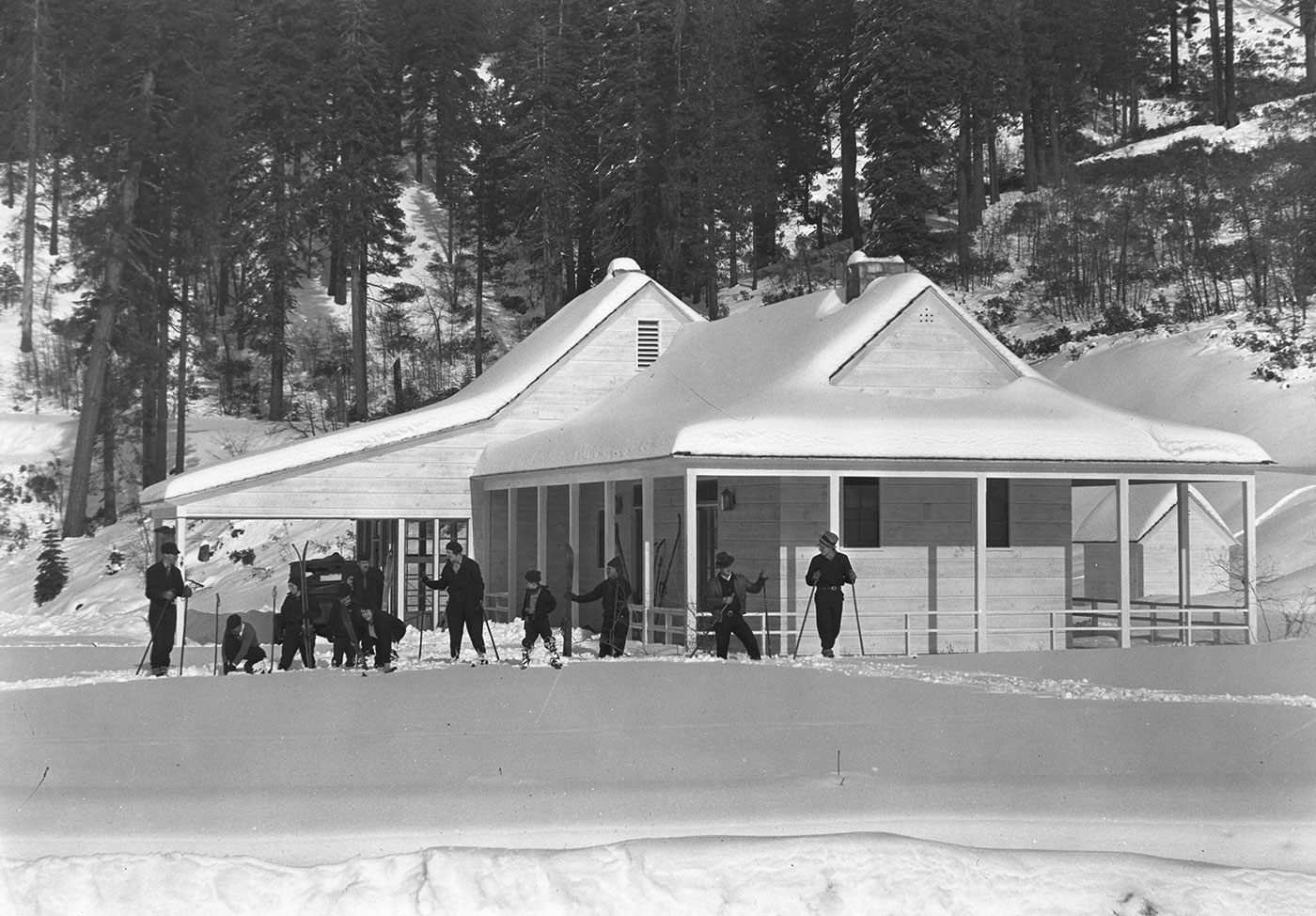 Historic photo of the Chinquapin Ski Hut with snow and skiers.