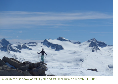 Skier in the shadow of Mt. Lyell and Mt. McClure.