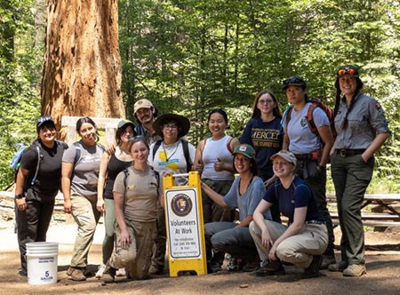 Group of trail volunteers in the field with intern and park staff