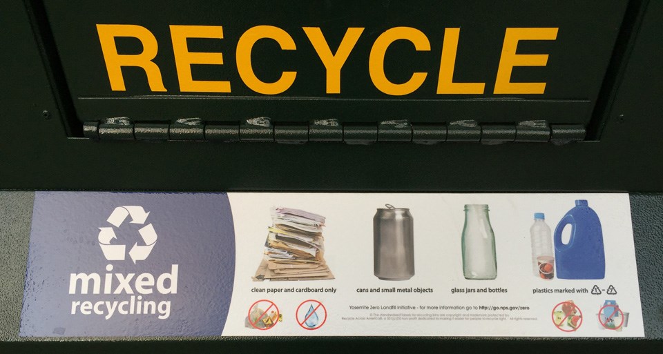 Sign showing mixed recycling can and associated symbols of what is expected in there.