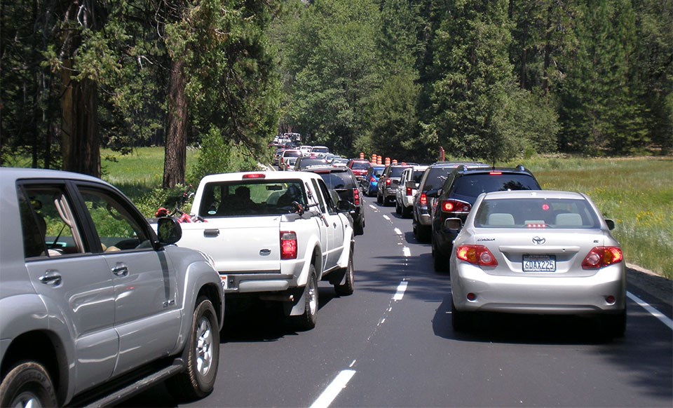 Two lines of cars at a standstill on crowded Yosemite Valley roadways.