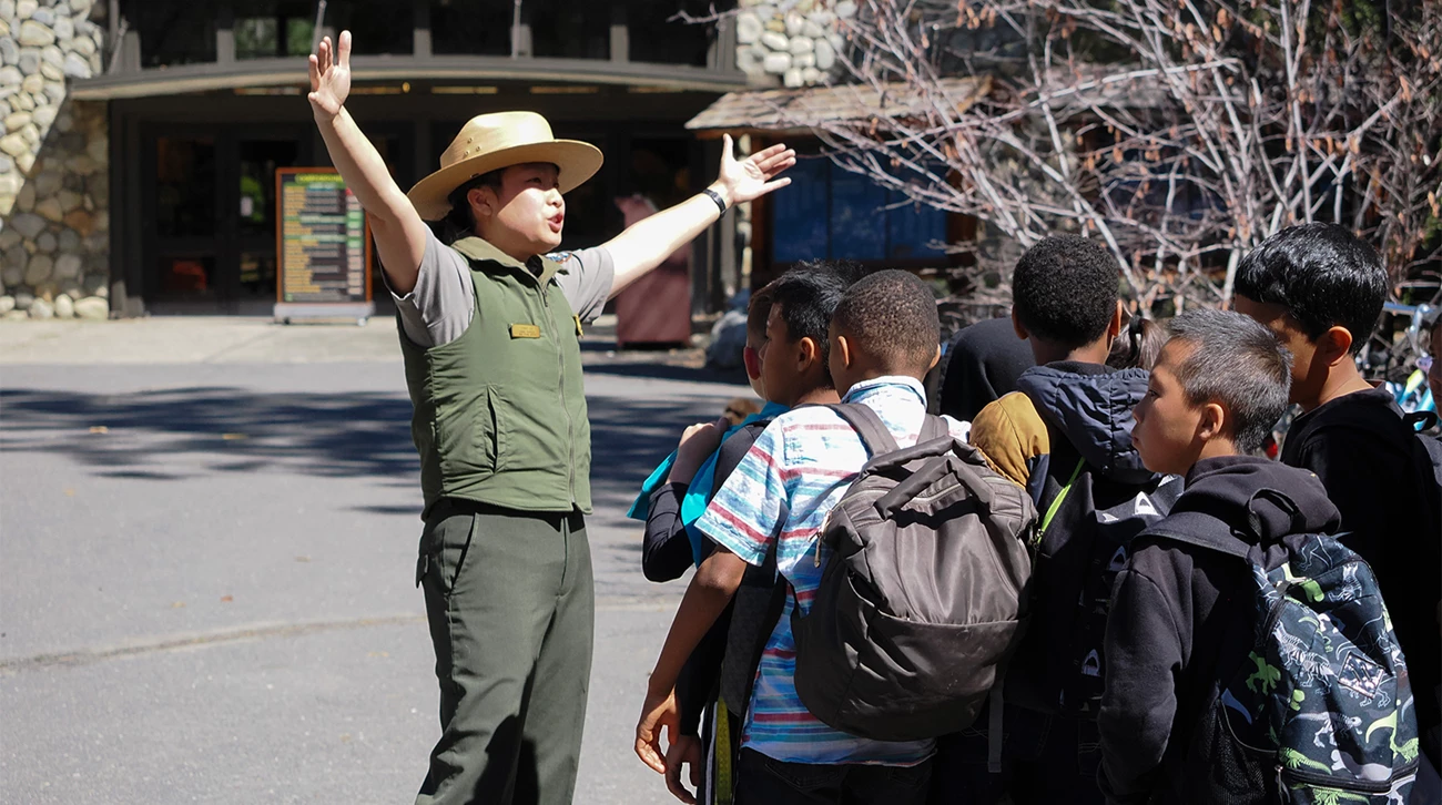Ranger with students in front of Exploration Center Ranger with students in front of Exploration Center