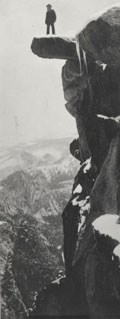 Galen Clark stands on a rock ledge high above the valley