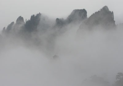 Mountain tops rise about the clouds