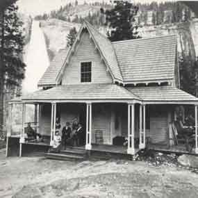 People sit on porch with waterfall in background